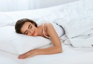 happy woman sleeping peacefully with a natural material pillow for a comfortable and healthy sleep experience