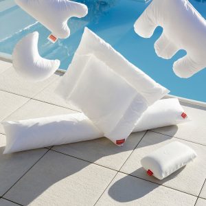 Six white pillows falling onto a bed - Tips for Maintaining Your Pillows